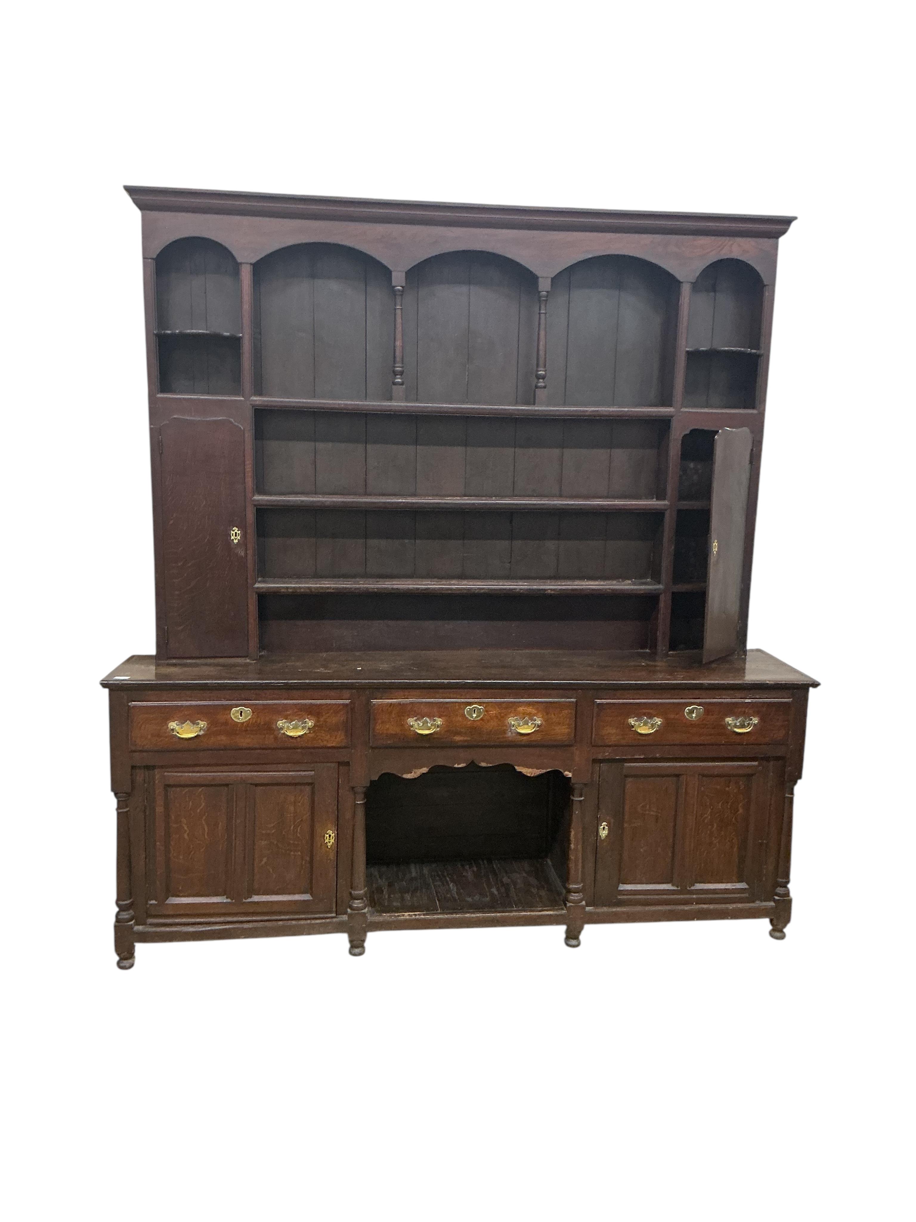 An 18th century and later oak 'dog kennel' dresser with boarded rack, width 216cm, depth 45cm, height 248cm